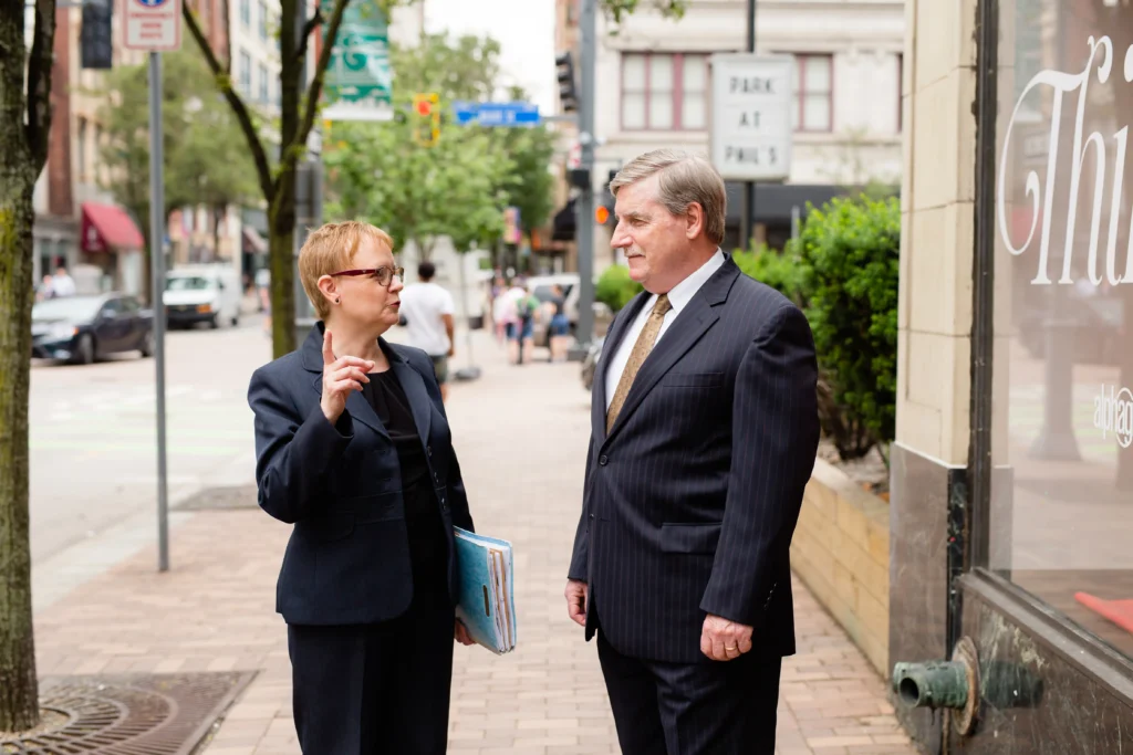 Abes Baumann, workers comp attorneys, talking to each other in Pittsburgh, PA